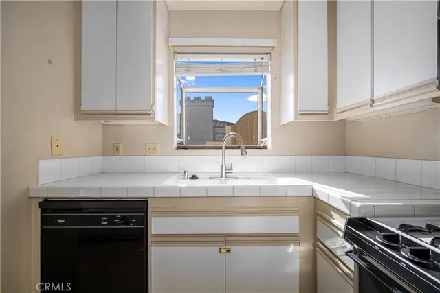 a kitchen with stainless steel appliances a refrigerator and cabinets
