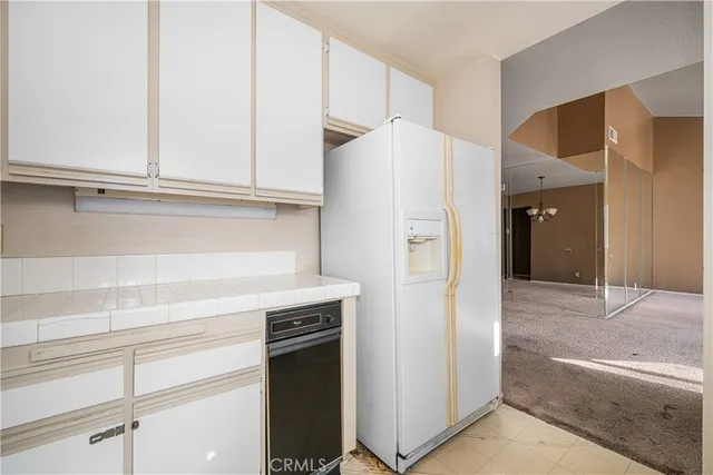 a view of a kitchen with a sink dishwasher refrigerator freezer a stove top oven with a dishwasher