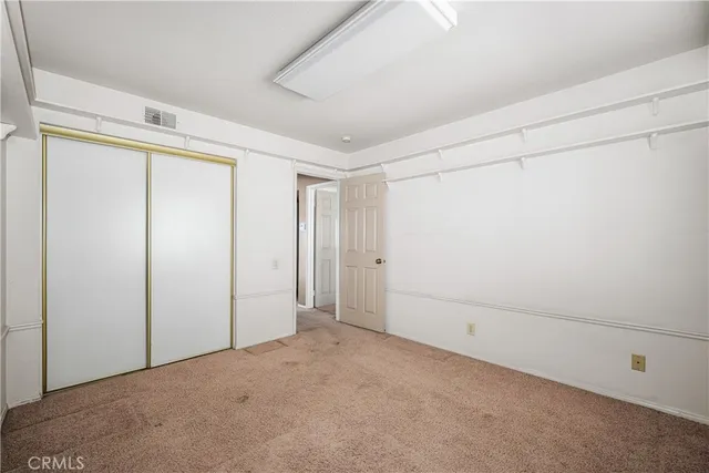 a bathroom with a granite countertop sink a toilet and a mirror
