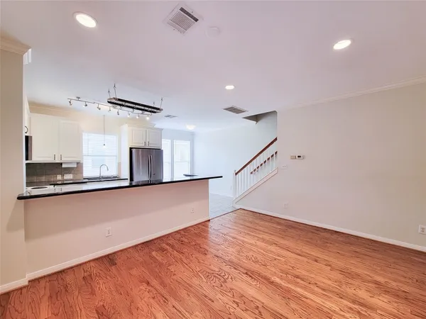 a view of a room with wooden floor and staircase