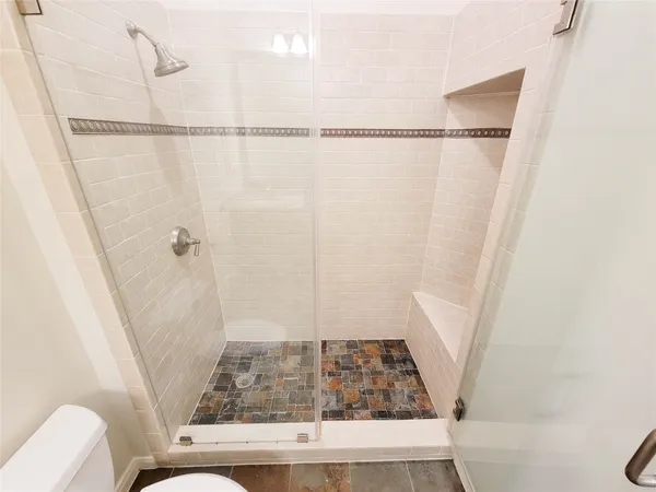 a bathroom with a shower and toilet