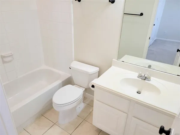 a white toilet sitting next to a bathroom sink