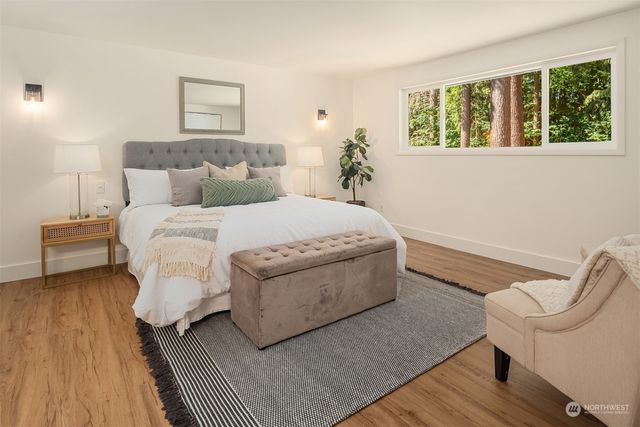 a bed room with a bed and a chair