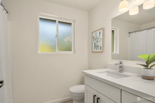 a view of patio with couches table and chairs under an umbrella with large trees