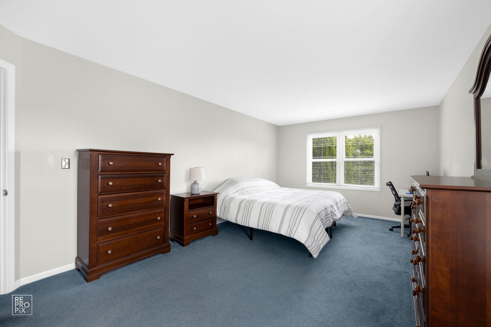 720 Small Court Naperville, IL 60563 - Photo 14 of 25 a bed sitting in a bedroom next to a window and dresser