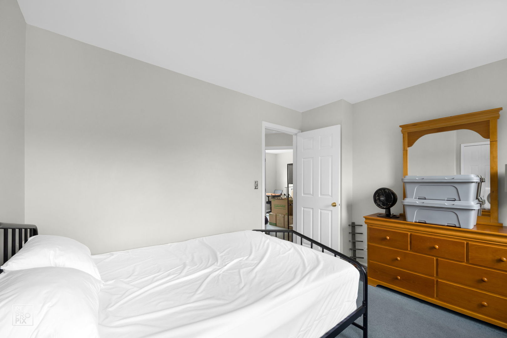 720 Small Court Naperville, IL 60563 - Photo 17 of 25 a bedroom with a bed and dresser with mirror