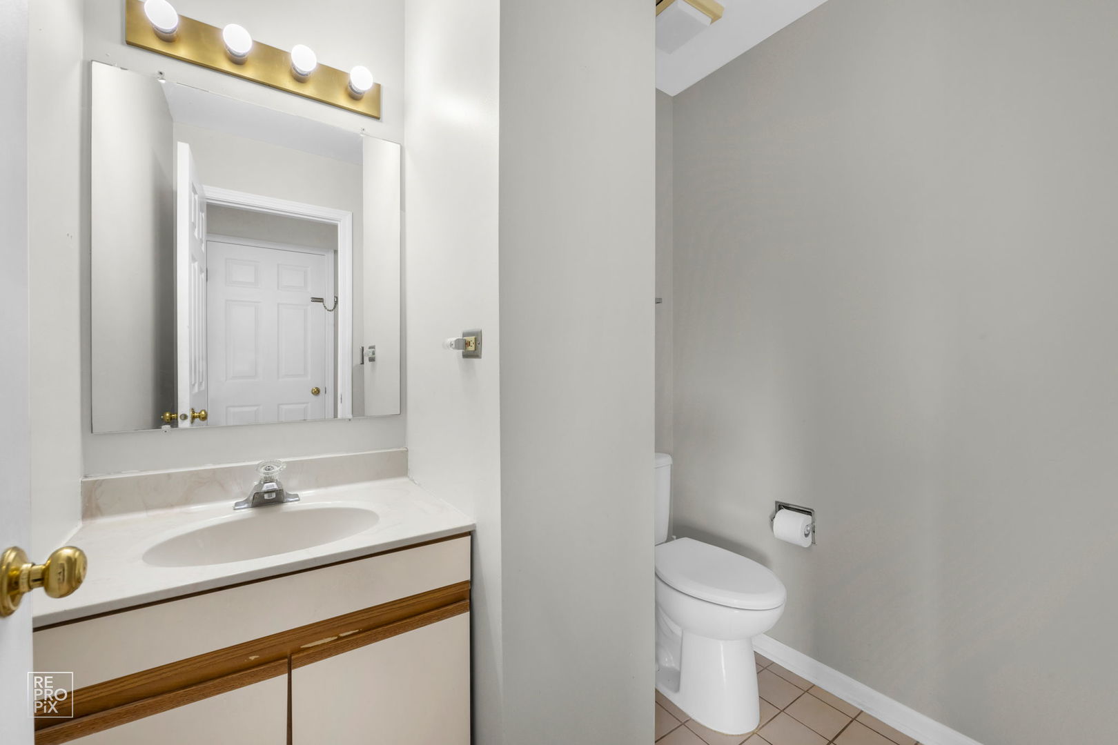 720 Small Court Naperville, IL 60563 - Photo 21 of 25 a bathroom with a sink a toilet and a mirror