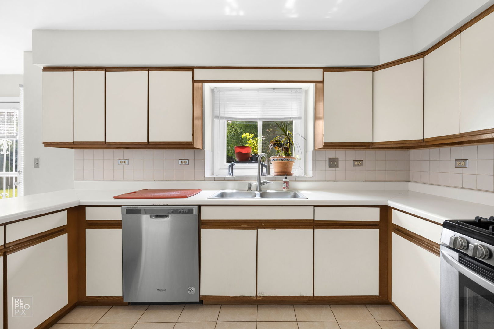 720 Small Court Naperville, IL 60563 - Photo 5 of 25 a kitchen with a sink cabinets and window