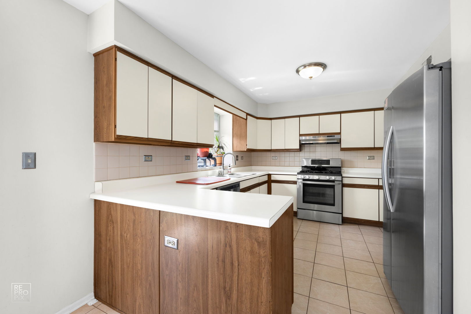 720 Small Court Naperville, IL 60563 - Photo 6 of 25 a kitchen with a sink cabinets stainless steel appliances and a window