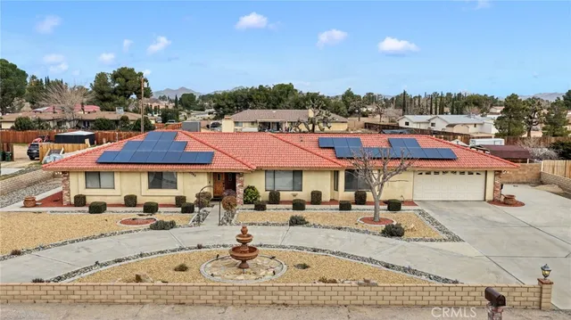 an aerial view of a house with a swimming pool