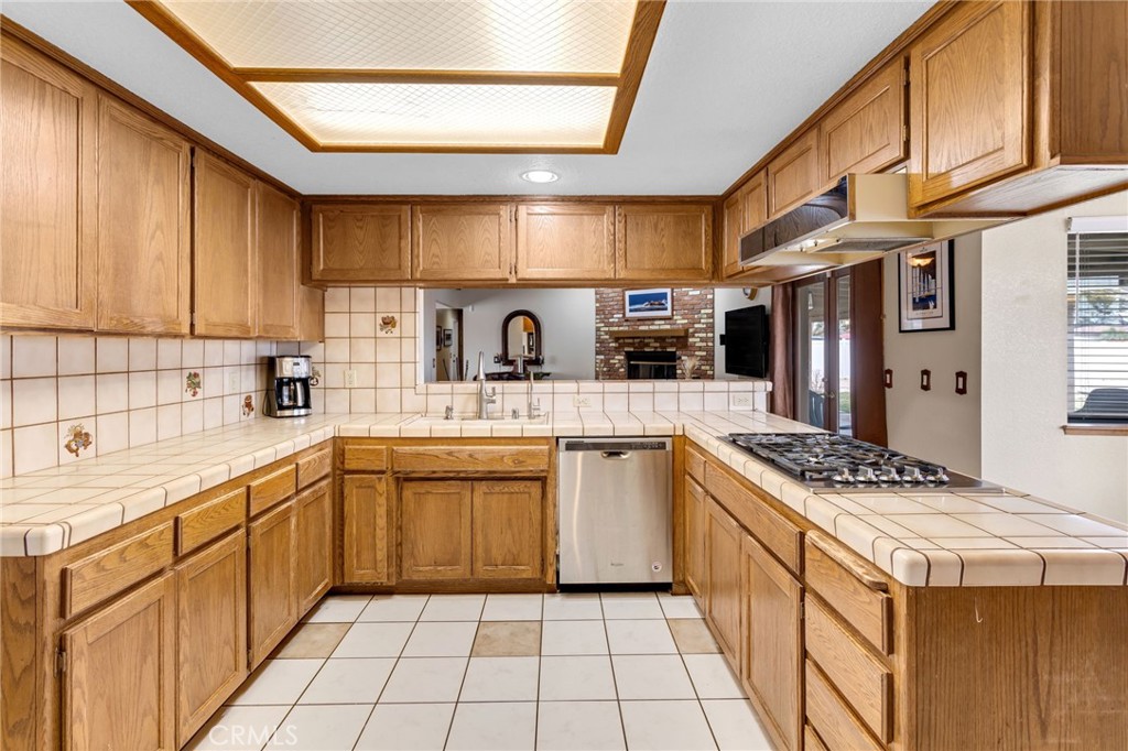 20360 Ituma Road Apple Valley, CA 92308 - Photo 15 of 66 a kitchen with stainless steel appliances kitchen island granite countertop a sink and cabinets