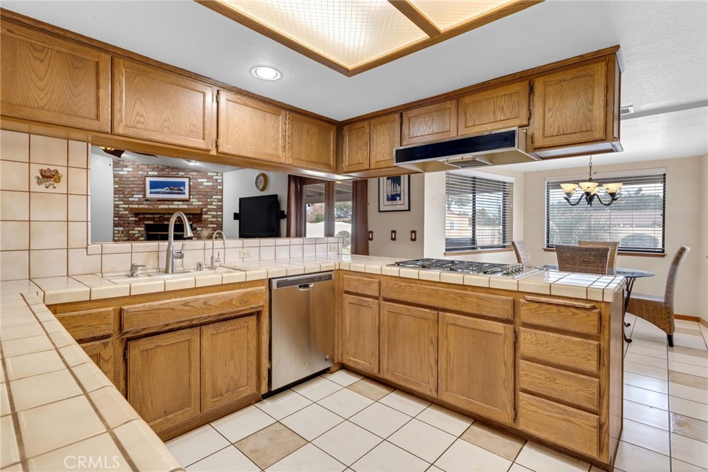 20360 Ituma Road Apple Valley, CA 92308 - Photo 16 of 66 a kitchen with stainless steel appliances granite countertop a sink and cabinets