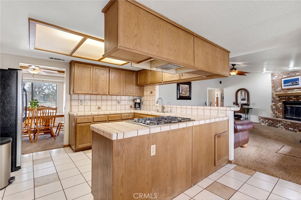 20360 Ituma Road Apple Valley, CA 92308 - Photo 18 of 66 a kitchen with stainless steel appliances granite countertop a sink a stove and a refrigerator