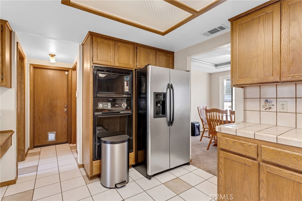 20360 Ituma Road Apple Valley, CA 92308 - Photo 19 of 66 a kitchen with a refrigerator sink and cabinets
