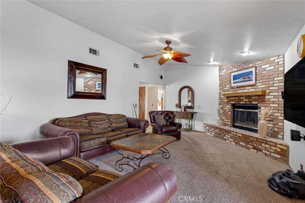 20360 Ituma Road Apple Valley, CA 92308 - Photo 20 of 66 a living room with furniture a flat screen tv and a fireplace
