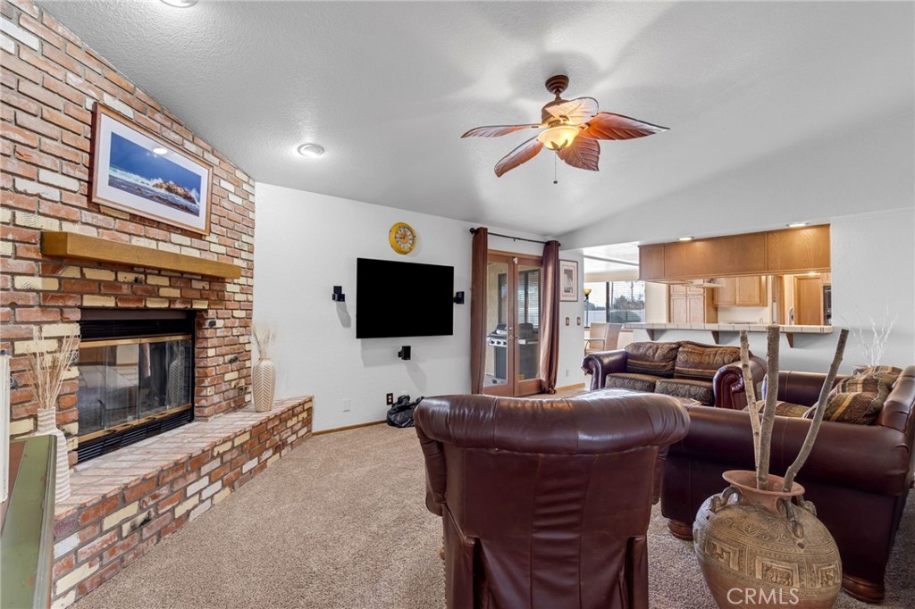 20360 Ituma Road Apple Valley, CA 92308 - Photo 23 of 66 a living room with furniture a flat screen tv and a fireplace