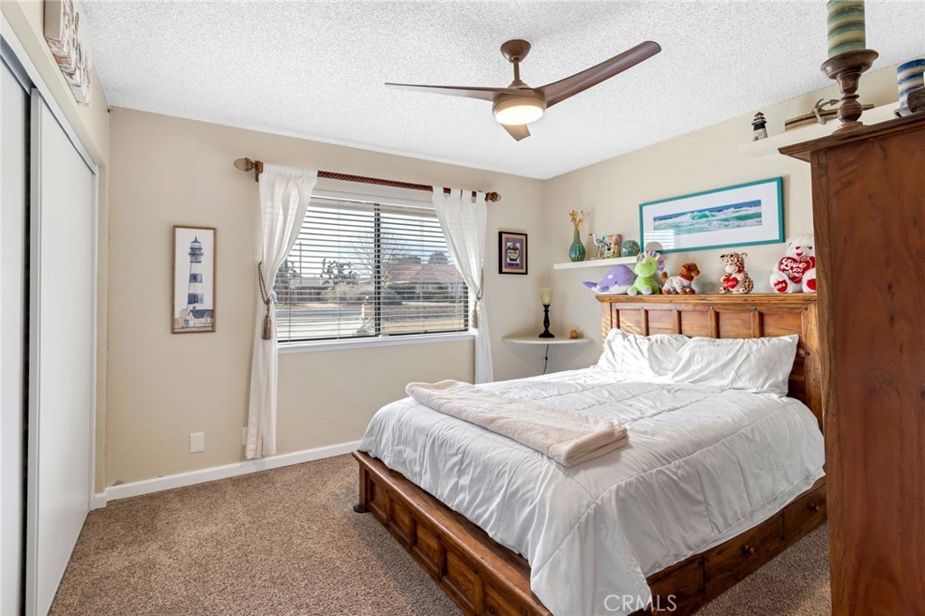 20360 Ituma Road Apple Valley, CA 92308 - Photo 24 of 66 a bedroom with a large bed and a window