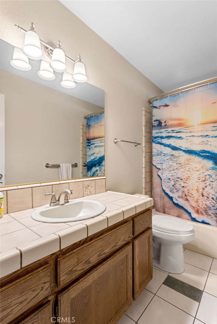 20360 Ituma Road Apple Valley, CA 92308 - Photo 28 of 66 a bathroom with a sink a toilet and a mirror