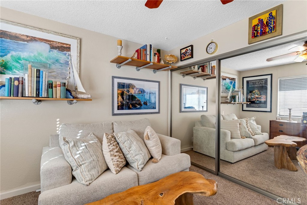 20360 Ituma Road Apple Valley, CA 92308 - Photo 31 of 66 a living room with furniture and a book shelf