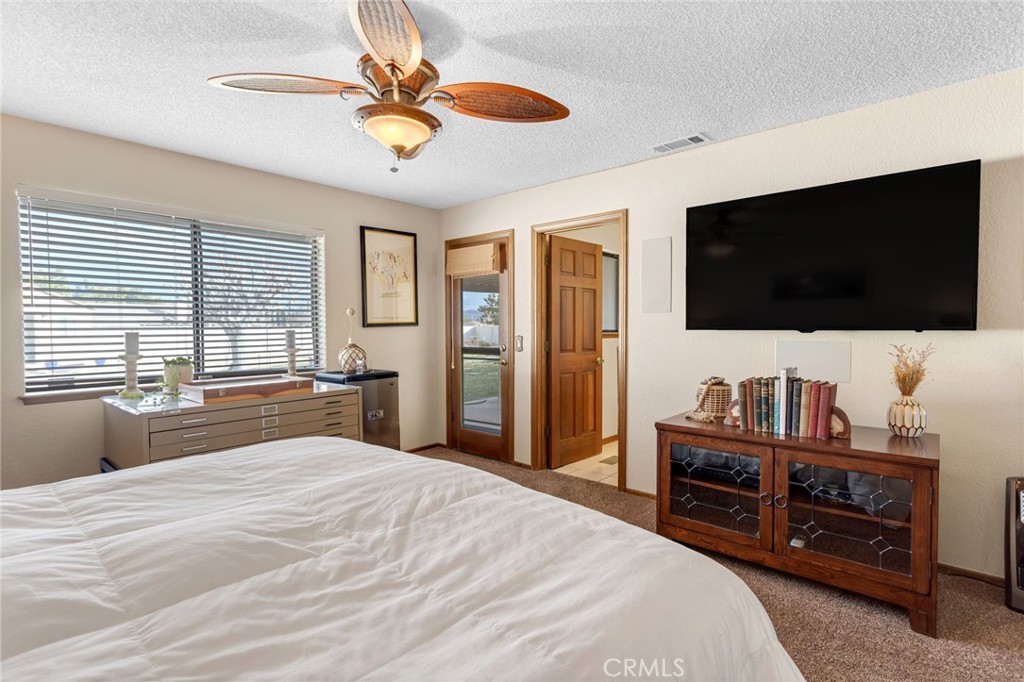 20360 Ituma Road Apple Valley, CA 92308 - Photo 33 of 66 a bedroom with a bed and a flat screen tv