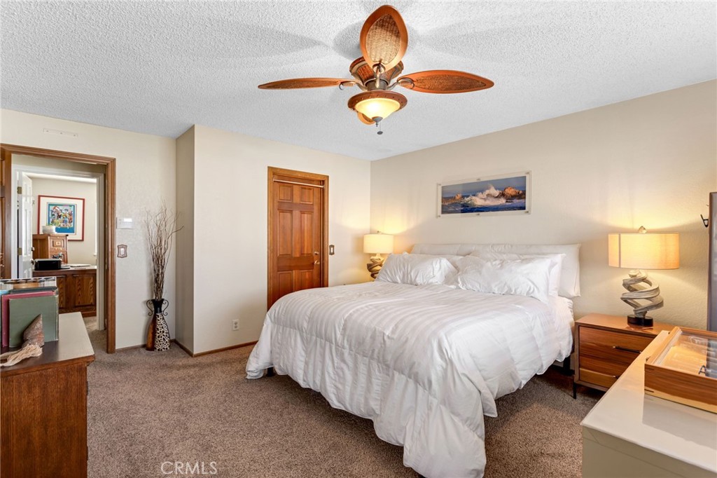 20360 Ituma Road Apple Valley, CA 92308 - Photo 34 of 66 a bedroom with bed and a chandelier