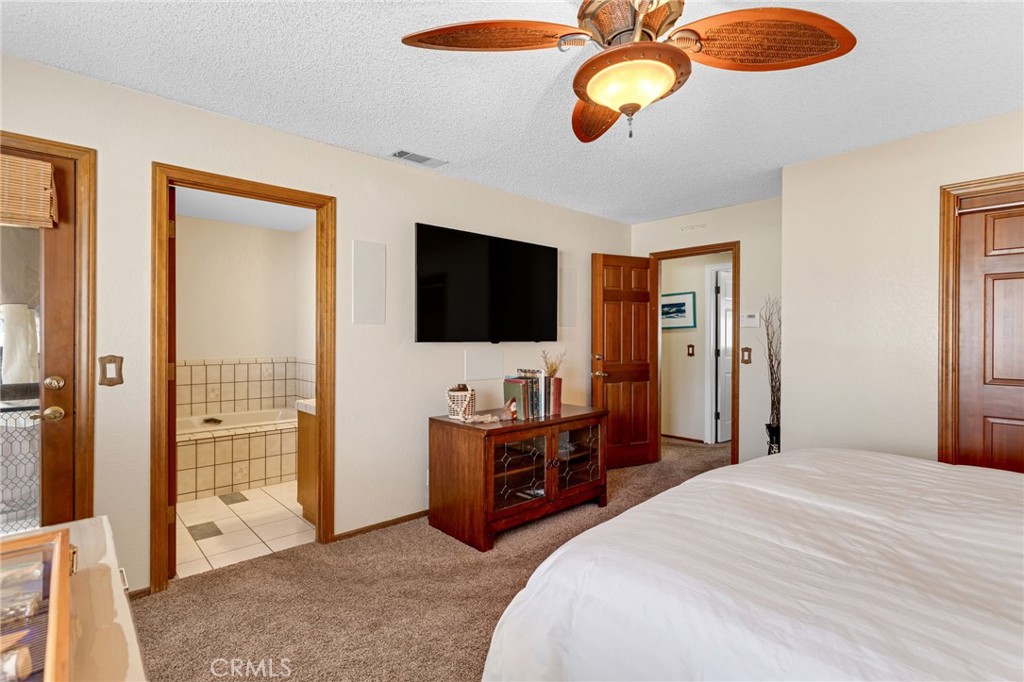 20360 Ituma Road Apple Valley, CA 92308 - Photo 35 of 66 a bedroom with a bed and a flat tv screen on dresser