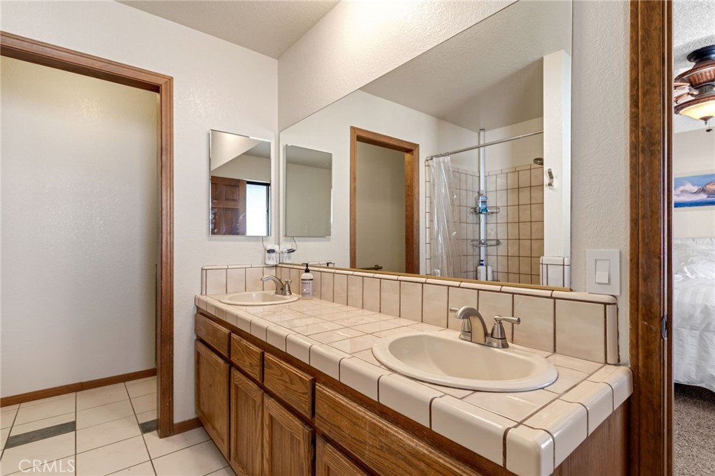 20360 Ituma Road Apple Valley, CA 92308 - Photo 37 of 66 a bathroom with a double vanity sink and a mirror