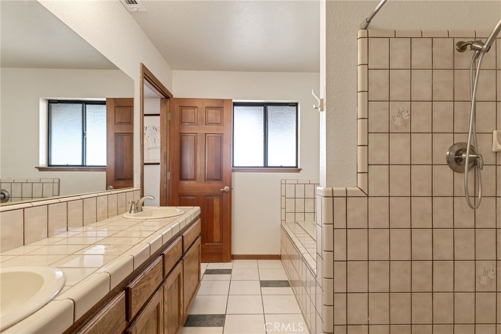 20360 Ituma Road Apple Valley, CA 92308 - Photo 38 of 66 a bathroom with a sink and a mirror
