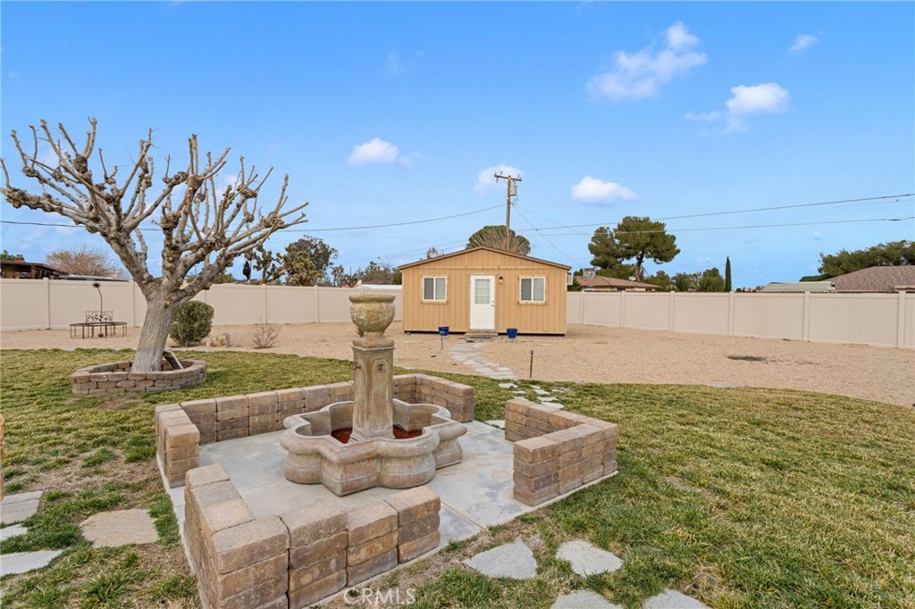 20360 Ituma Road Apple Valley, CA 92308 - Photo 46 of 66 a front view of a house with garden