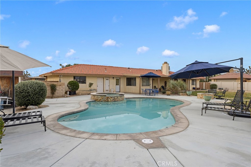 20360 Ituma Road Apple Valley, CA 92308 - Photo 54 of 66 a view of a house with swimming pool and sitting area