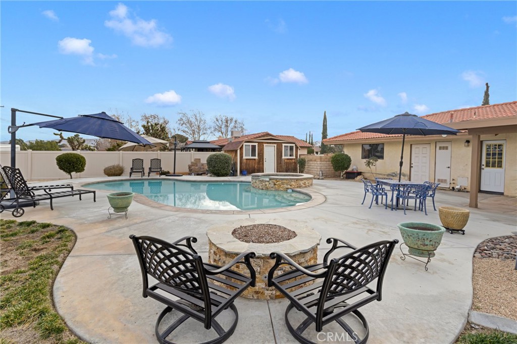 20360 Ituma Road Apple Valley, CA 92308 - Photo 56 of 66 a view of a patio with dining table and chairs with wooden floor