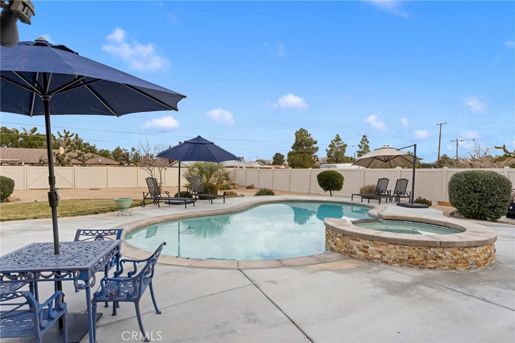 20360 Ituma Road Apple Valley, CA 92308 - Photo 57 of 66 a view of a swimming pool and lounge chairs