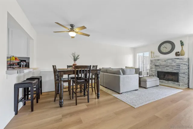 a living room with furniture a fireplace and a table