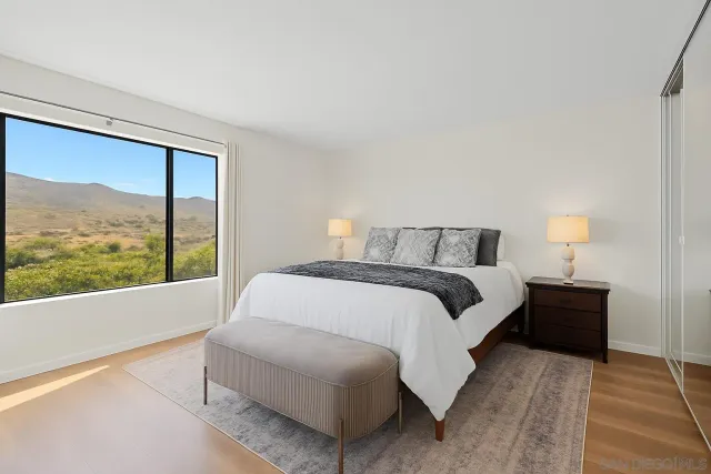 a bedroom with a large bed and a large window