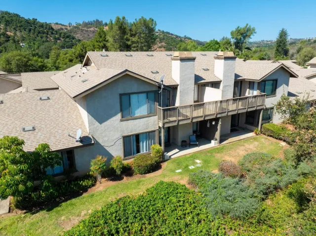 a view of a house with a swimming pool and a yard