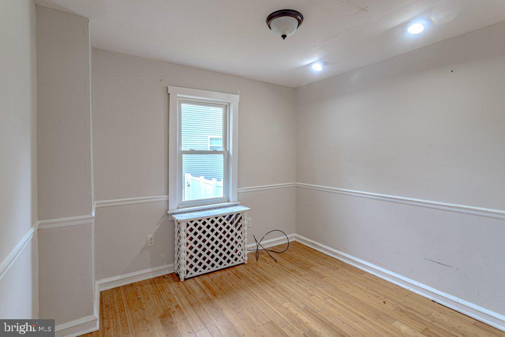 329 Union Avenue Runnemede, NJ 08078 - Photo 12 of 29 an empty room with wooden floor and windows
