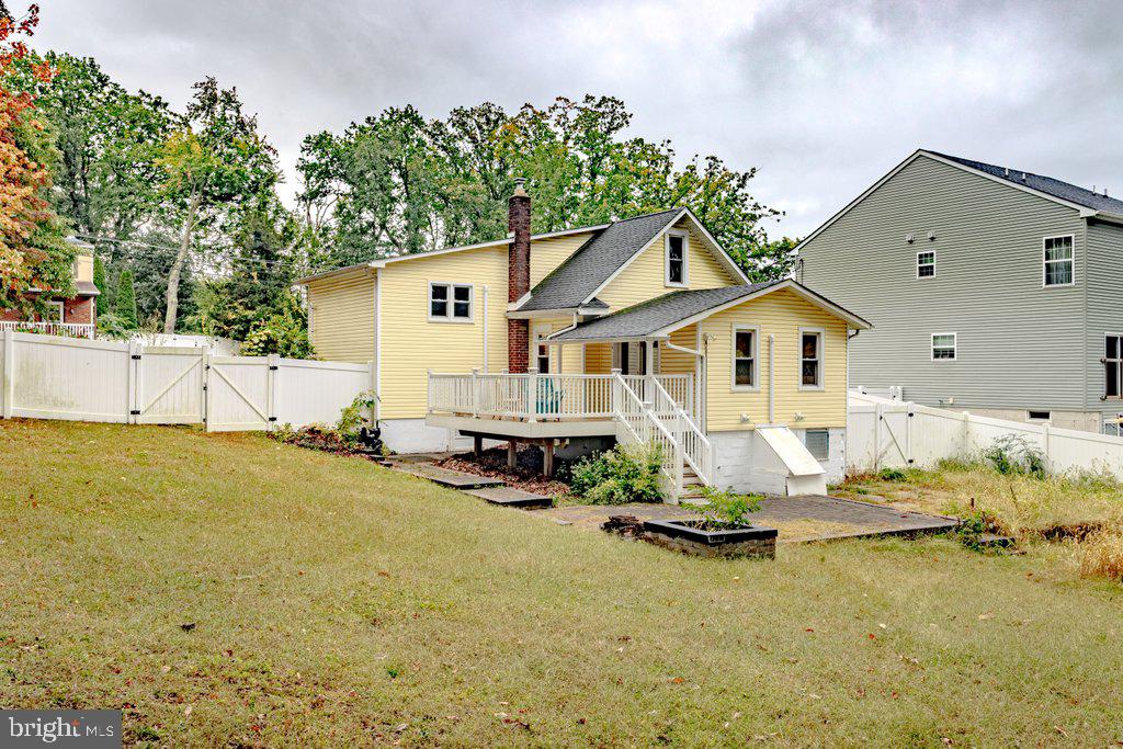 329 Union Avenue Runnemede, NJ 08078 - Photo 28 of 29 a view of a backyard with table and chairs in front of yellow house