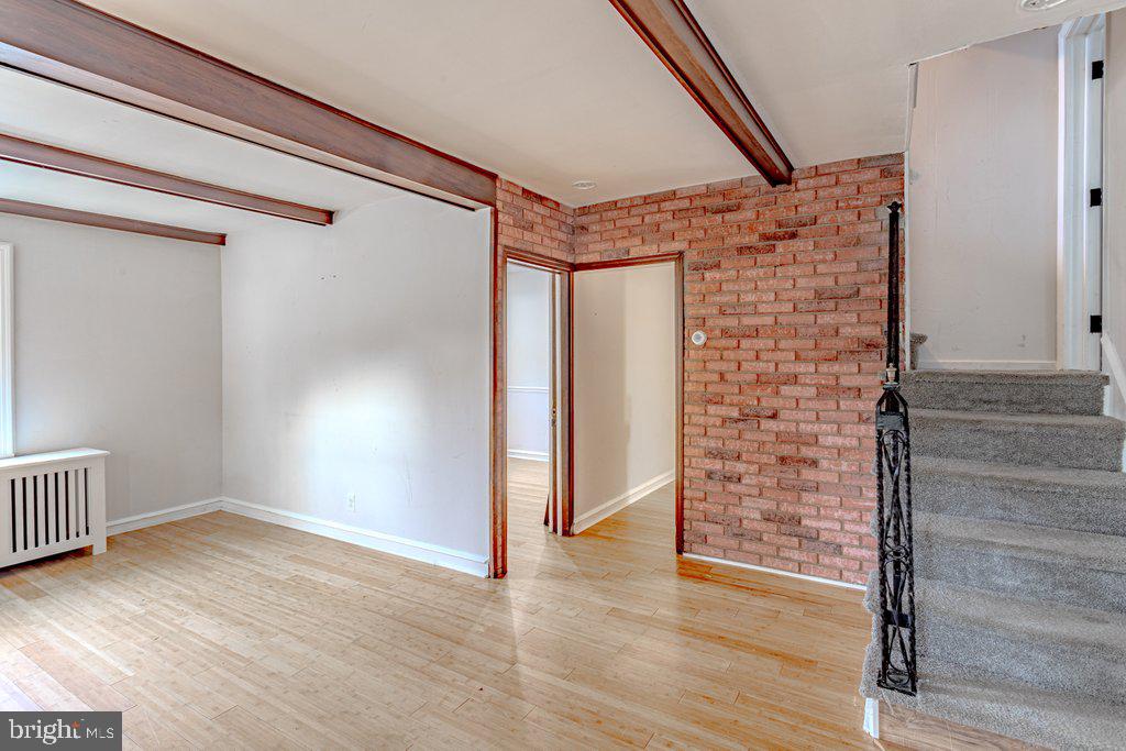 329 Union Avenue Runnemede, NJ 08078 - Photo 4 of 29 a view of an empty room with wooden floor and windows