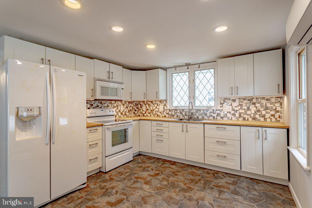329 Union Avenue Runnemede, NJ 08078 - Photo 7 of 29 a kitchen with granite countertop white cabinets and white appliances