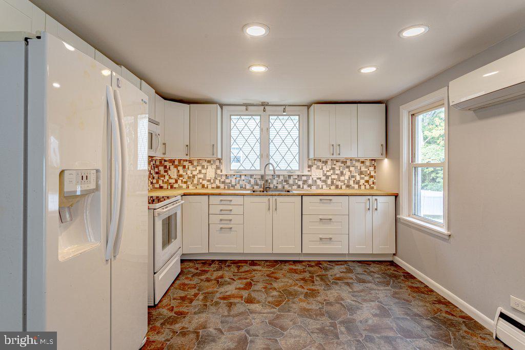 329 Union Avenue Runnemede, NJ 08078 - Photo 8 of 29 a view of cabinets a large window and a refrigerator