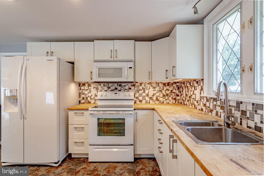 329 Union Avenue Runnemede, NJ 08078 - Photo 10 of 29 a kitchen with white cabinets sink and white appliances