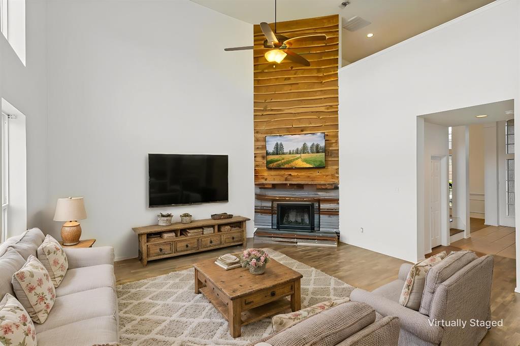 4107 Waverly Road Corinth, TX 76208 - Photo 7 of 30 The spacious family room is warmed by a wood-burning fireplace with gas starter and rustic accents.