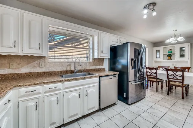 a kitchen with granite countertop cabinets and stainless steel appliances
