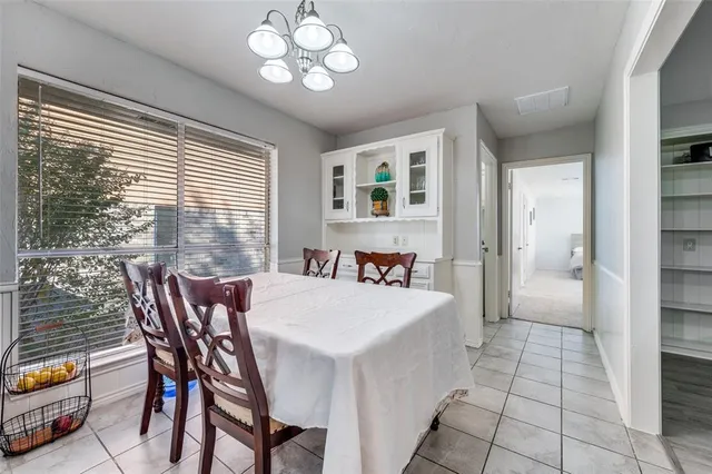 a view of a dining room with furniture and a chandelier