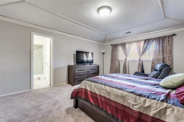 a bedroom with a bed and a television