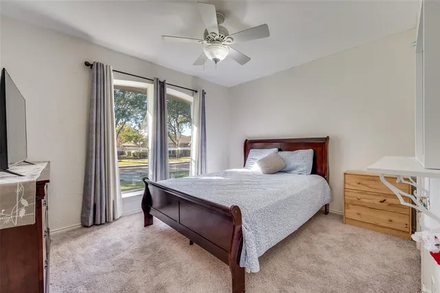a spacious bedroom with a bed and a chandelier