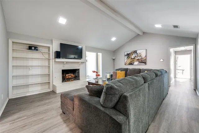 a living room with furniture and a fireplace