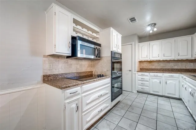 a kitchen with appliances cabinets and a sink