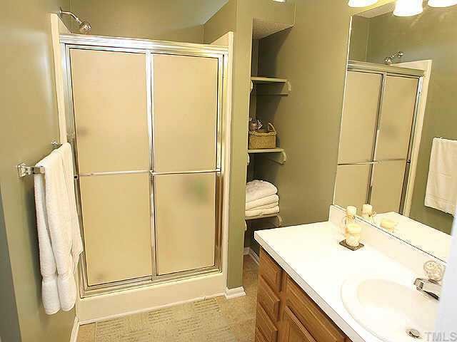 7109 Kinross Drive Raleigh, NC 27613 - Photo 6 of 9 a bathroom with a sink and a mirror