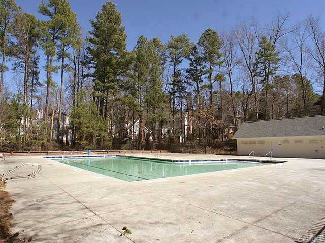 7109 Kinross Drive Raleigh, NC 27613 - Photo 8 of 9 a view of a swimming pool with an outdoor space and seating area